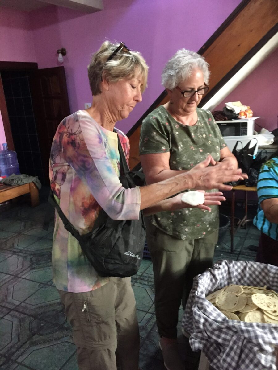 Tour participants learn about Guatemalan culture by making tortillas
